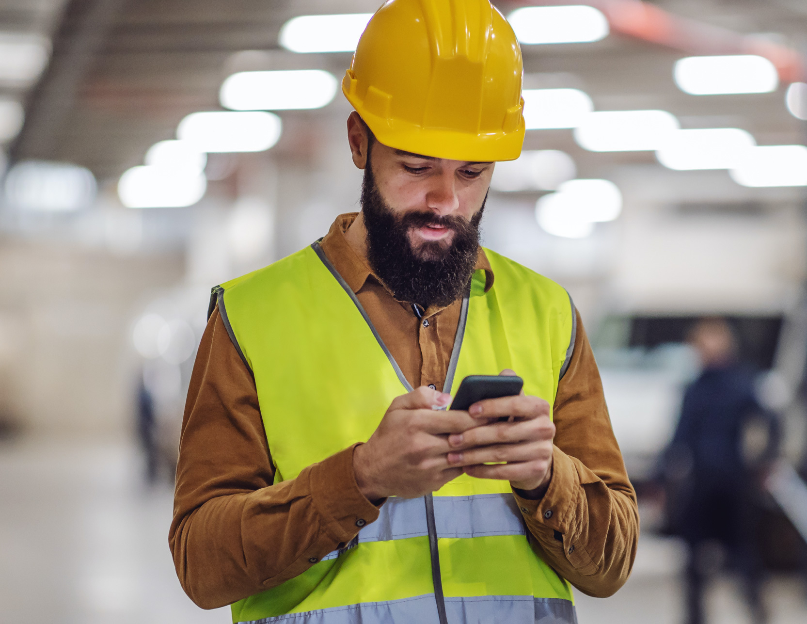 Construction Worker looking at phone