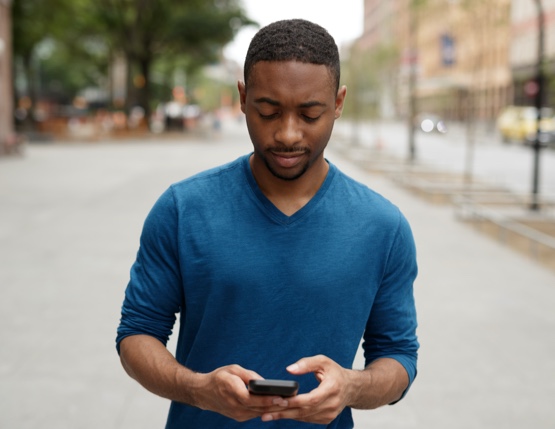 man looking at a mobile device