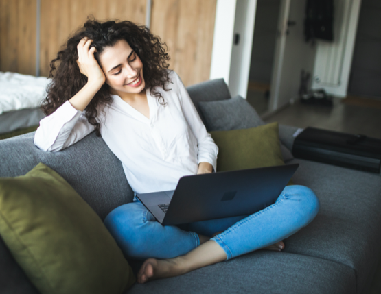 woman on couch on a laptop